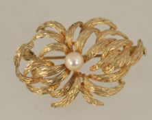 A hallmarked 9ct gold and pearl brooch with trombone clasp. Import marks for London. Measures 3.