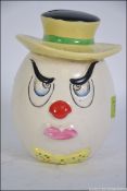 A retro / vintage ceramic swear / mood box in the form of a scowling clown,