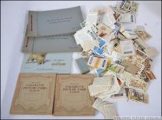 An excellent collection of cigarette cards in albums along with loose and collections banded loose.