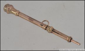 A 9ct gold 19th century propelling pencil with rococo chase decoration. Total weight 3.