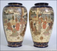 A pair of early 20th century Japanese hand painted Kutani vases with a blue ground having central