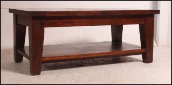 A contemporary good quality hardwood coffee table of rectangular form with squared legs and drawers