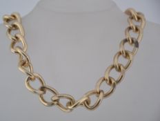 A vintage chunky yellow metal curb chain necklace with lobster claw clasp.
