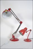 A contemporary 20th century anglepoise style desk lamp having a red pendant shade raised on a
