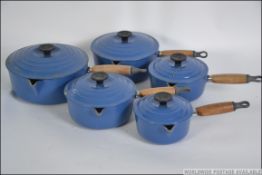 A vintage 20th century Le Crueset saucepan set of heavy form in blue and white two tone colours