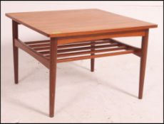 A good square mid century Danish influence teak coffee table raised on tapered angled supports with