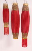 A set of 3 vintage Chinese lanterns of cylindrical form with red paper and wooden ends.