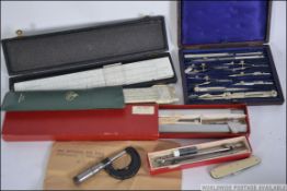 A collection of draughtmans bits to include a cased draughtmans set,