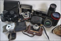 A collection of cameras and lenses to include Voitlander SLR, Beirette and others.