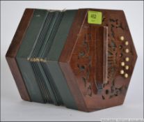 An 20th century squeezebox of mahogany