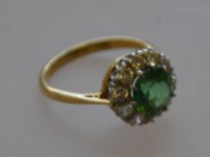 A marked 18ct and platinum green stoned