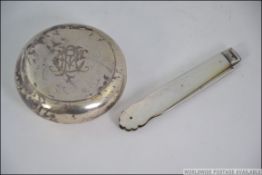 A silver pill shaped snuff box with hall