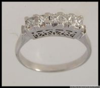 A platinum and diamond 5 stone ring with