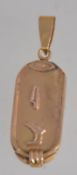 An 18ct gold necklace pendant with Egyptian hieroglyphics. Size 3.5cms long / Weight 2.