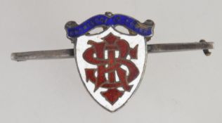 A late Victorian enamel and silver hallmarked brooch with coat of arms and motto ' knowledge is