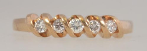 A hallmarked 9ct gold ladies diamond ring with approx 20 pts of diamonds set in a spiral twist