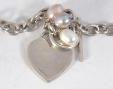 A hallmarked 925 silver necklace with heart and pearl charm with toggle clasp.