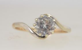 A 9ct gold and white sapphire ring. The single stone being claw mounted with 1ct round cut stone.