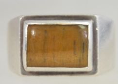 A large vintage gentlemans silver signet ring with large inset polished tigers eye agate stone.