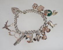 A good silver belcher linked charm bracelet having a total of 11 charms to include an amazing glass