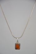 A silver 925 snake linked fine necklace chain with inset amber stone pendant.