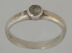 A 925 silver ring with a CZ in a bezel setting. Size P. Marked 925.