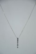 A modernist silver fine linked necklace with drop pendant inset with baguette cut cz stones.