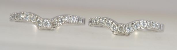 A pair of matching silver 925 and cz channel set stone rings.
