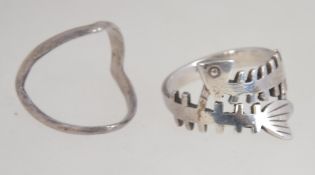 A contemporary silver fishbone ring together with another silver ring of unusual form. Size O.
