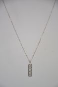A silver 925 curb linked necklace chain with C clasp having a foliate pierced drop pendant of