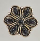 A large vintage ladies silver and amathyst stone oversized flower head cocktail ring.