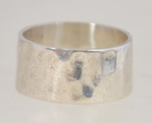A contemporary silver 925 band ring of hammered form. Weight 5.