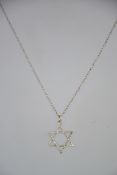 A fine silver chain linked necklace with star shaped pendant. marked 925. Weight 3.
