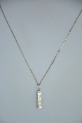 A silver box linked necklace with silver ingot hallmarked pendant for London 1979. Weight 5.