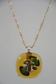 An atomic linked silver ladies necklace chain adorned with a coloured glass large pendant.