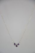 A contemporary silver and 3 stone amethyst pendant necklace. The chain measurs 42cms / weight 2.