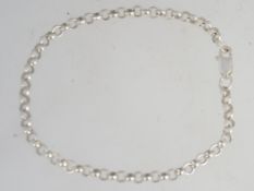 A silver rolo linked christening bracelet with lobster clasp. Size 18cms. Weight 3.