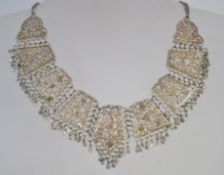 A silver Asiatic - Indian choker necklace and chain of filigree work complete with bale drops.