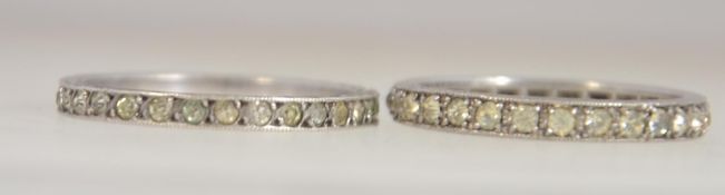 2 silver eternity rings, both being channel stone set. Total weight 3.2g / Size O & N.