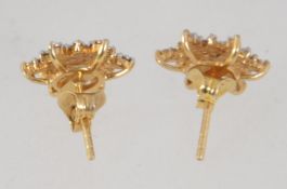 A pair of gold plated 925 silver earrings set with diamond chips in the form of stars.