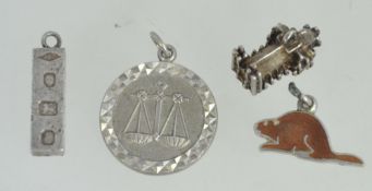 A collection of 5 silver charms to include cathedral, wombat, hallmarked ingot,