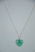 A contemporary silver 925 curb linked necklace chain with a C clasp having a green glass heart