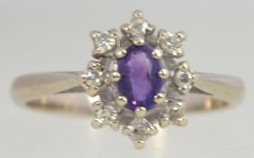 A 18ct gold diamond and amethyst ladies cluster dress ring with approx 20 pts of diamonds set