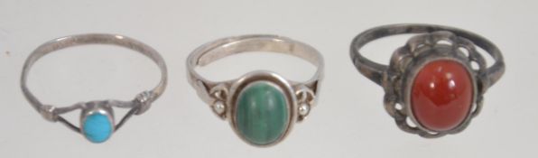 A collection of 4 silver and agate set ladies rings.