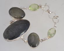 A contemporry 925 silver and agate stone bracelet with green oval quartz stones having bale and bar