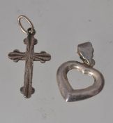 Two 925 silver necklace pendants in the form of a heart marked 925 and a crucifix marked Silver.