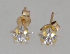 A pair of 9ct gold crystal stud earring in the form of star with post backs. Marked 9ct. Tests 9ct.