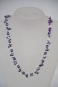 A baroque contemporapy pearl and glass necklace with silver lobster claw clasp.