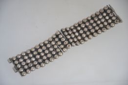 A silver white metal Islamic / Ethnic metamorphic bracelet of ball finial form with long pin clasp
