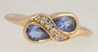 A hallmarked 9ct gold ladies dress ring with diamonds in a swivel setting with adjacent tear drop